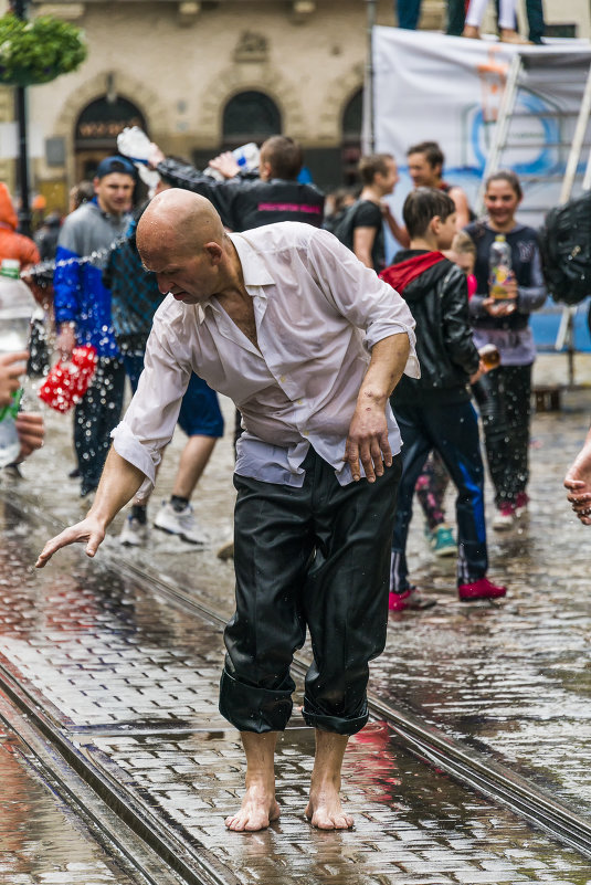 Bald man dancing among a people - Сергей 