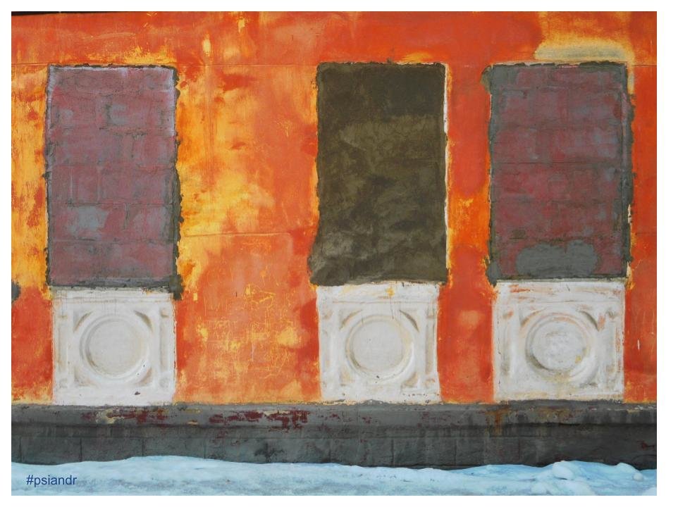 Оранжевая стена дома с заложенными окнами - Павел Андреев